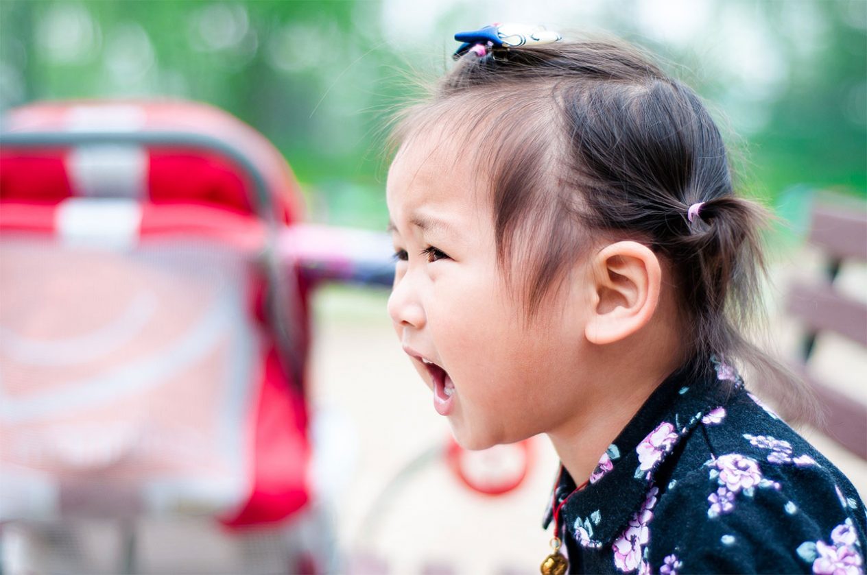 closeup of angry anxious little girl screaming