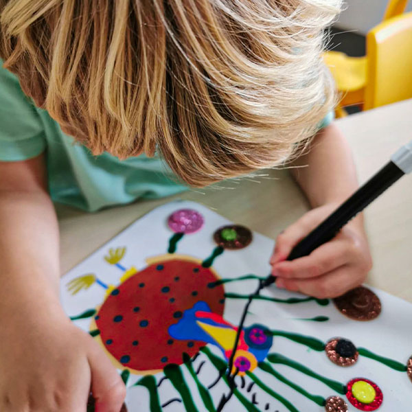 Chicky & Olive student creating turkey art based on Chicky Little storybook