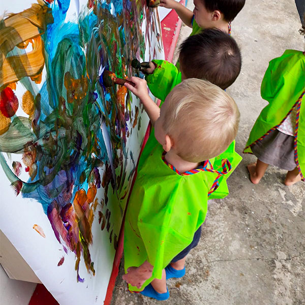 Chicky & Olive students painting on canvas outdoor