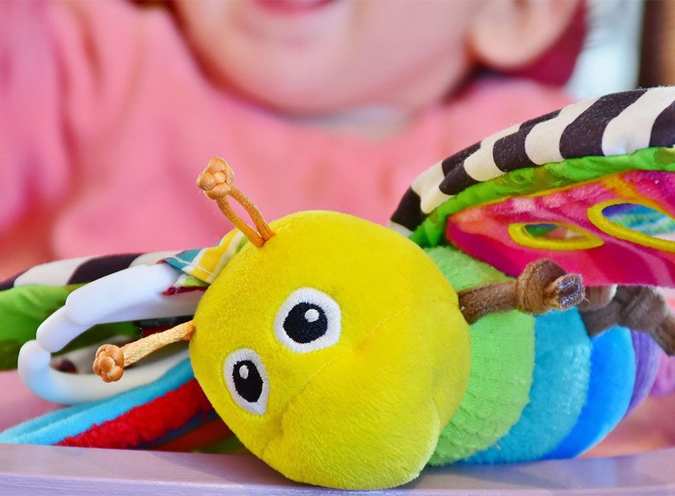 closeup of a child's colorful bee soft toy
