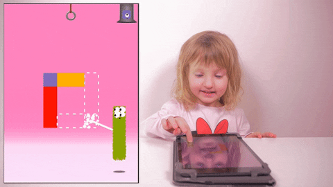 Little girl playing puzzle games on iPad