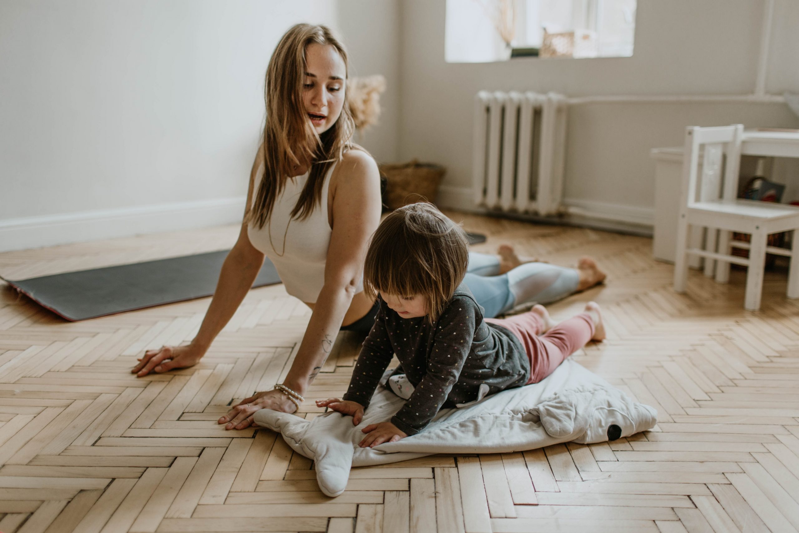 Mother and daughter doing yoga at home