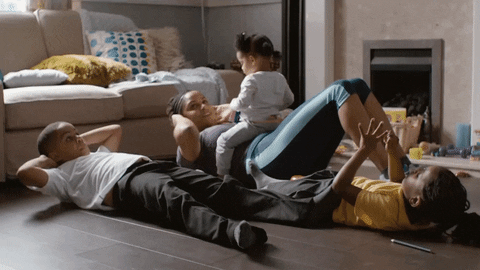 Mother exercising with kids at home