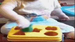 smart baby playing with shape sorting toy