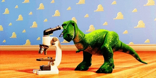 Toy Story Rex looking into a microscope